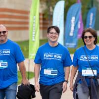 Participants nearing finish line smiling as they pass by